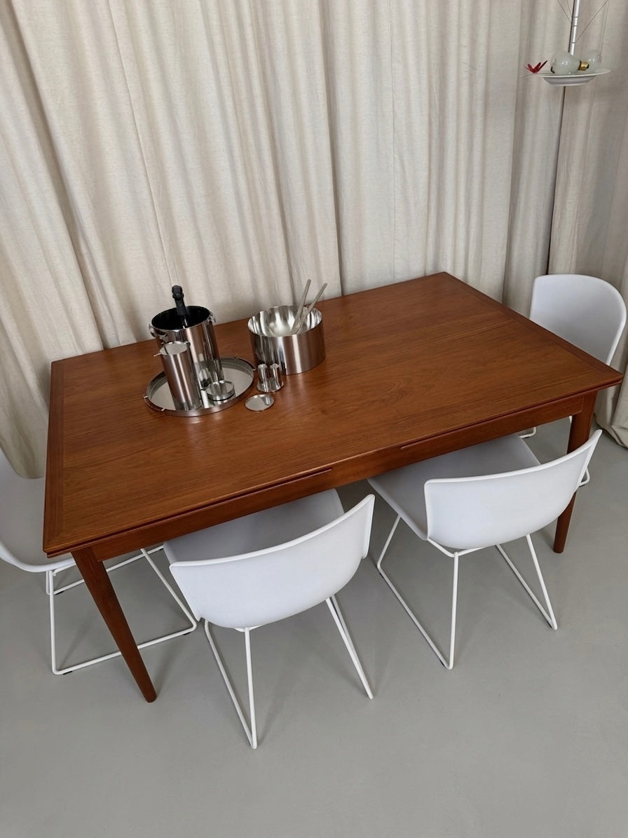Teak dining table with draw leaf extensions