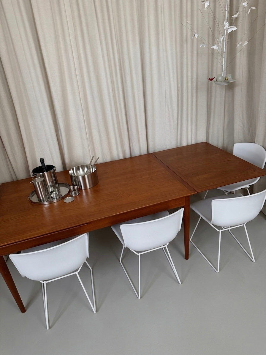 Teak dining table with draw leaf extensions