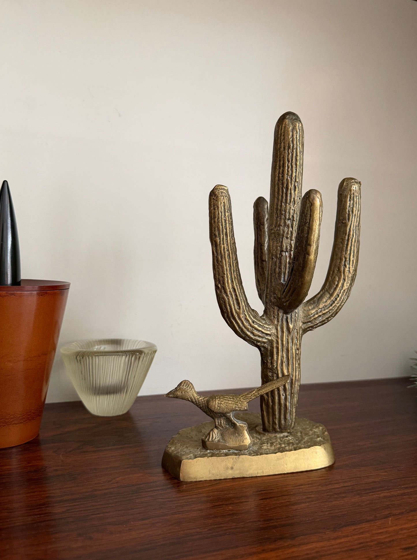 Brass roadrunner and cactus sculpture