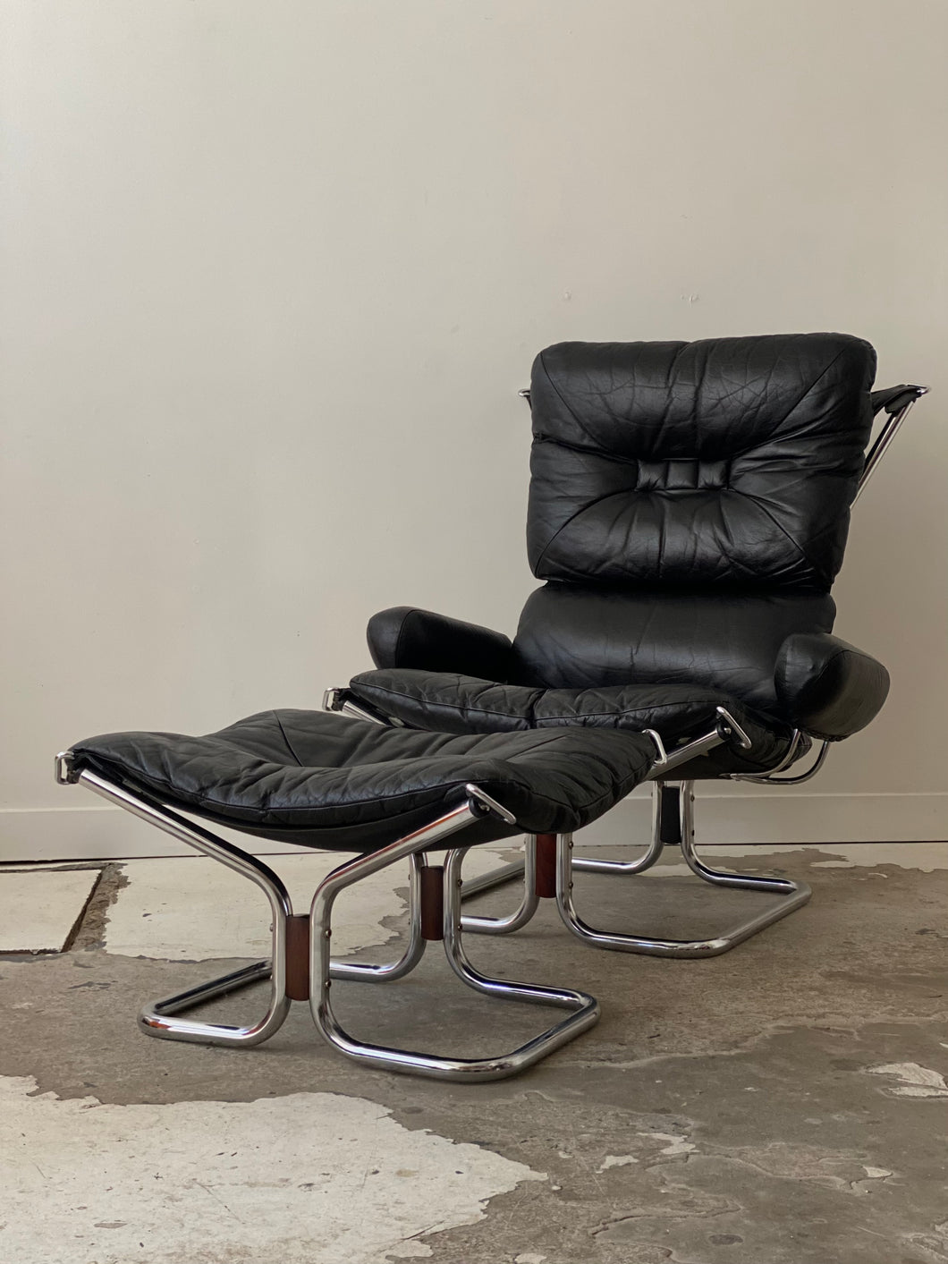 Black leather lounge chair and ottoman by Harald Relling for Westnofa
